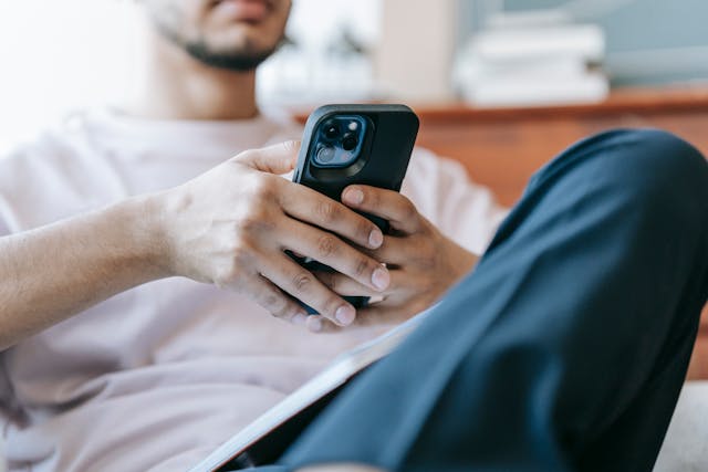 Person holding a cellphone with both hands